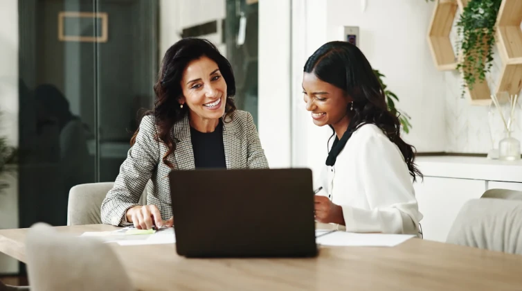 Two women sitting at a table talking