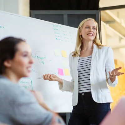 A woman presenting to colleagues