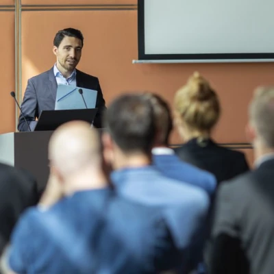 Man standing at podium speaking to audience