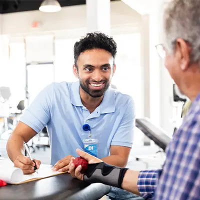 Male physical therapist working with patient