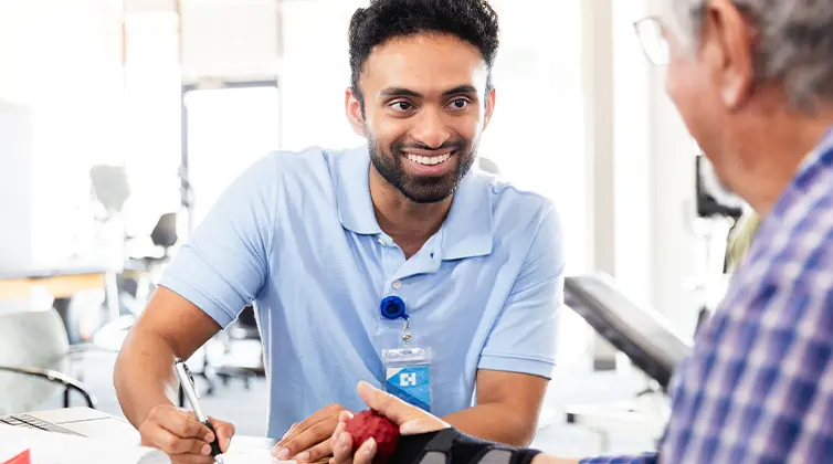Male physical therapist working with patient