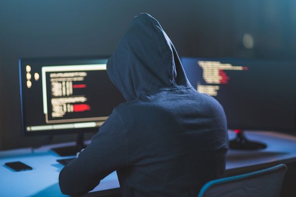 cyber criminal hacking at desktop computer