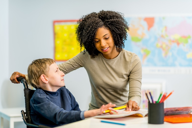 special education teacher with student