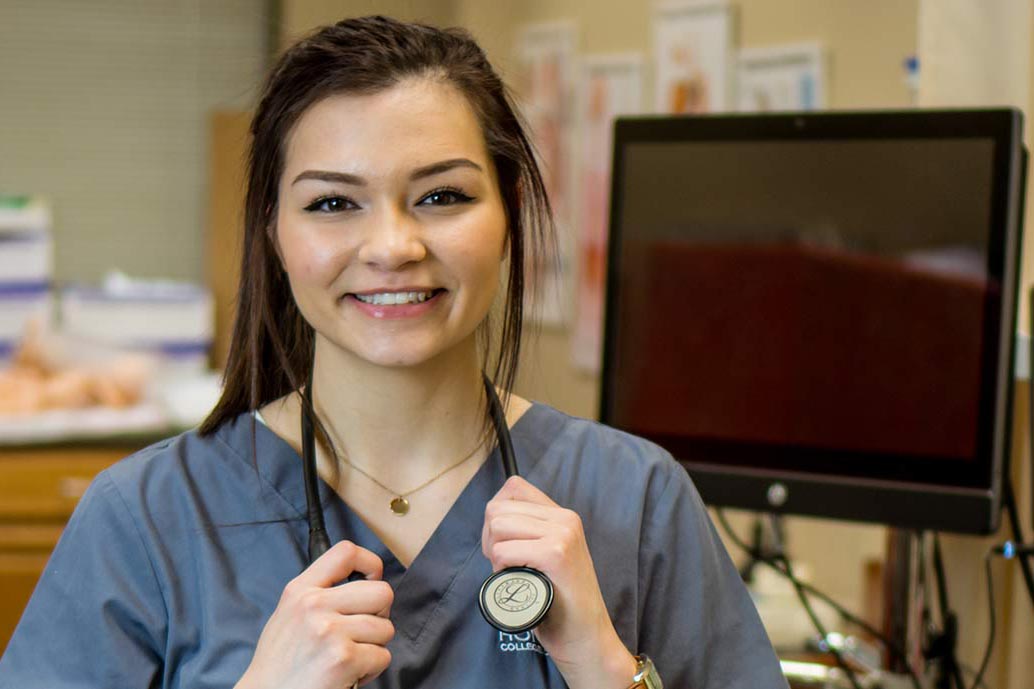 female nurse smiling with stethoscope around neck